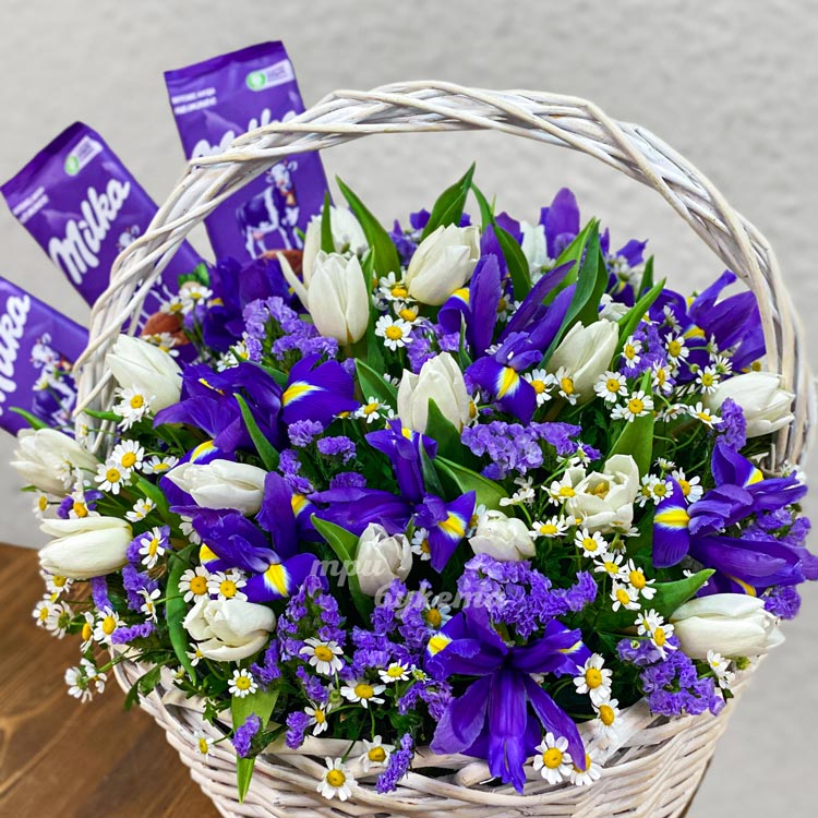 Корзина ирисов и тюльпанов с плитками шоколада (крупный план)